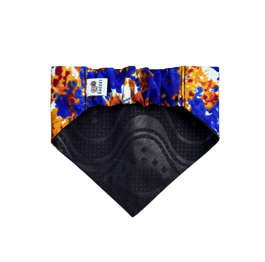 A scrunchie dog bandana with colorful patterned border on a white background