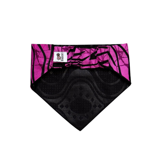 Black and pink patterned dog bandana with a brand label on a white background