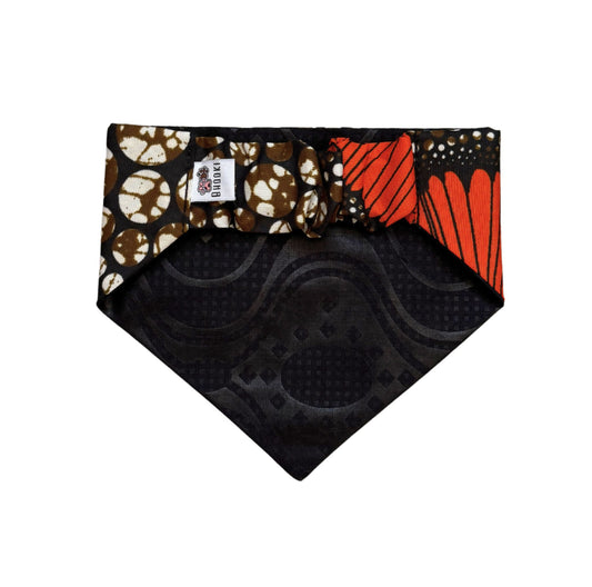 Scrunchie Dog bandana with black base, brown and white pattern, and orange design on a white background.
