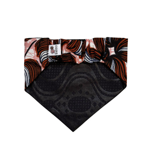A colourful pink and brown scrunchie Dog bandana with black pattern  back on a white background