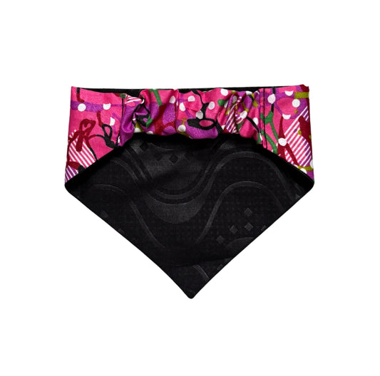 Black scrunchie dog bandana with colorful patterned border on a white background