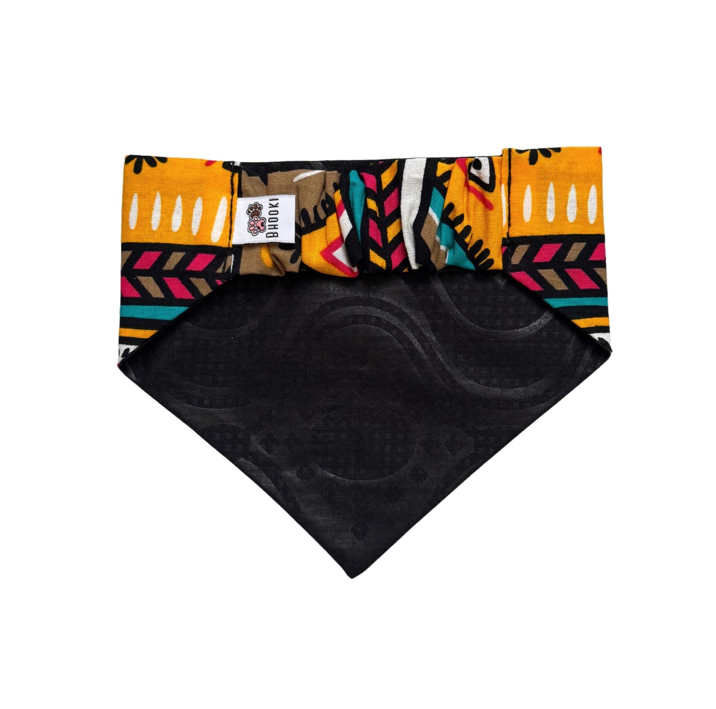Colorful patterned dog bandana with a black backing on a white background