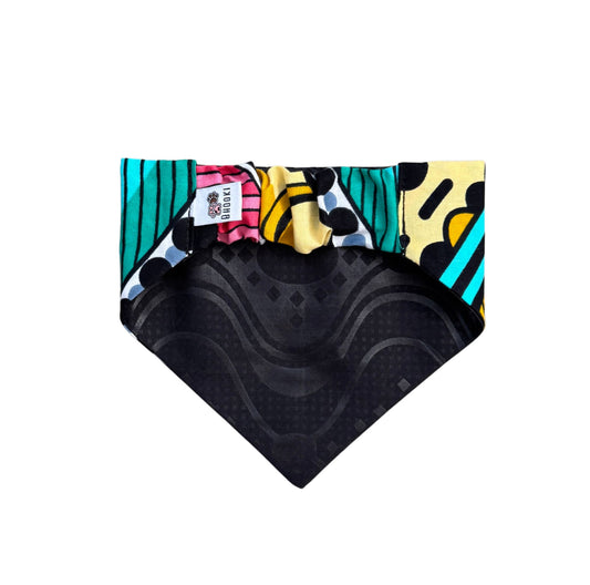 A colourful scrunchie dog bandana with a black patterned fabric at the back