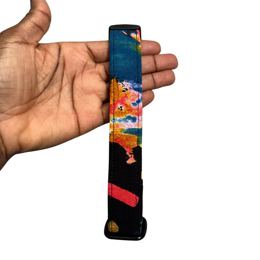 Colorful dog collar held in a hand against a white background