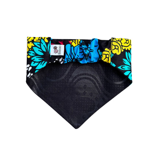 A scrunchie dog bandana with colorful floral pattern on a white background